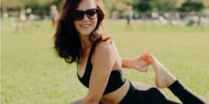 Woman wearing sunglasses doing yoga