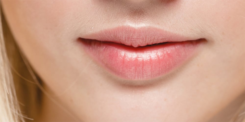 Close up of a woman's mouth, lips closed